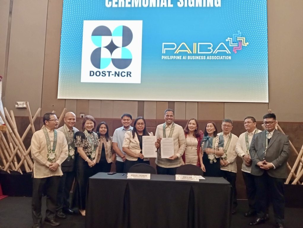 Jerry Ilao and the DOST-NCR Regional Director holding the signed memorandum of understanding at the ceremonial signing