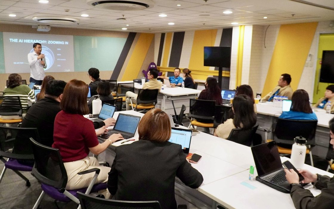 AI workshop classroom in the Philippines with business participants working on laptops