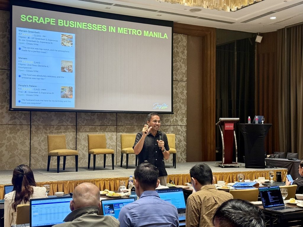 Jerry Ilao on stage demonstrating practical AI for businesses at a Philippine conference