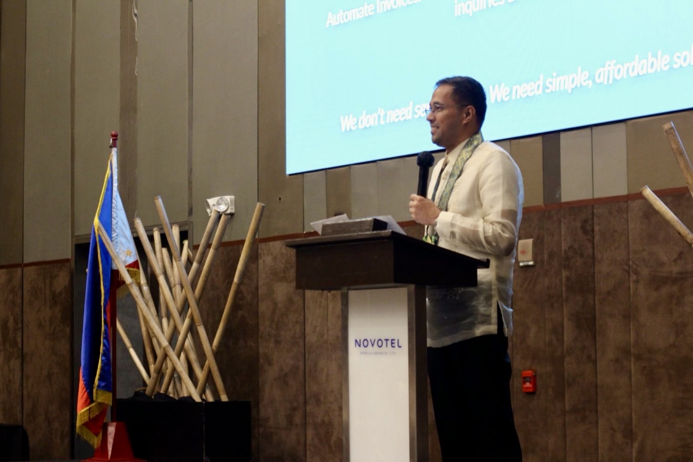 Jerry Ilao delivering a keynote at a hotel business conference