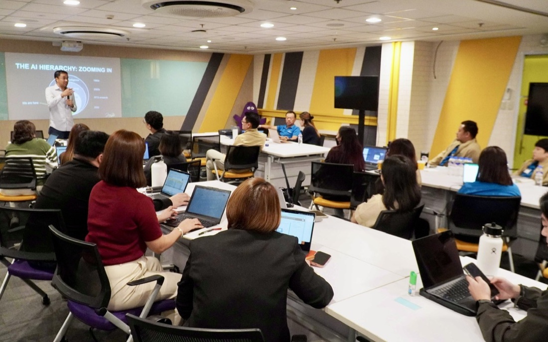 Full workshop room of participants working on laptops